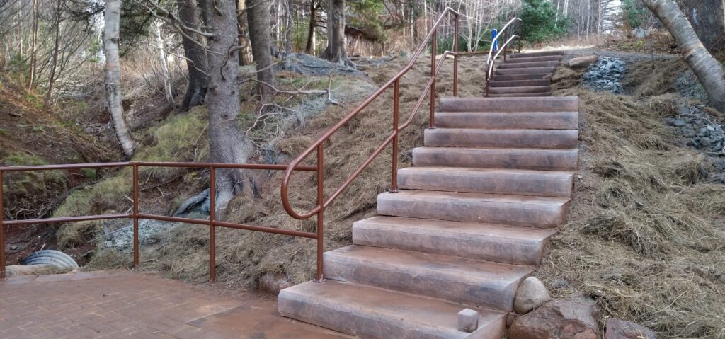 Red sandstone steps leading down a hill.