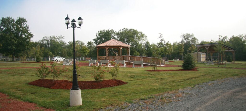 A park featuring a gazebo and flower beds.