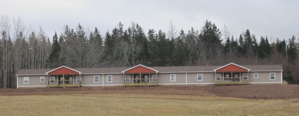 A single-storey beige multi-unit residence.