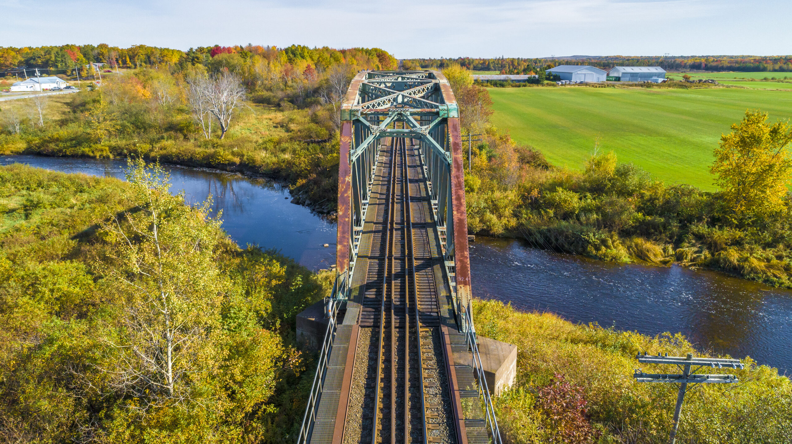Aerial shot of train bridge over a river in Nine Mile River