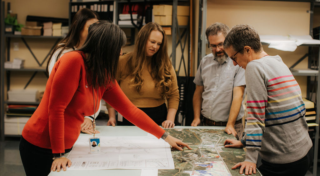 Planning team consulting a large map