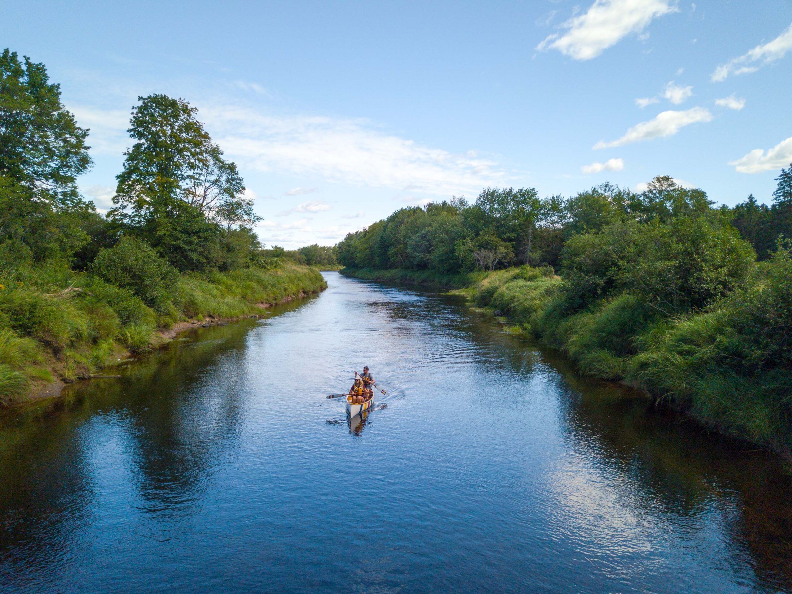 two paddlers kayak down the Shubenacadie River