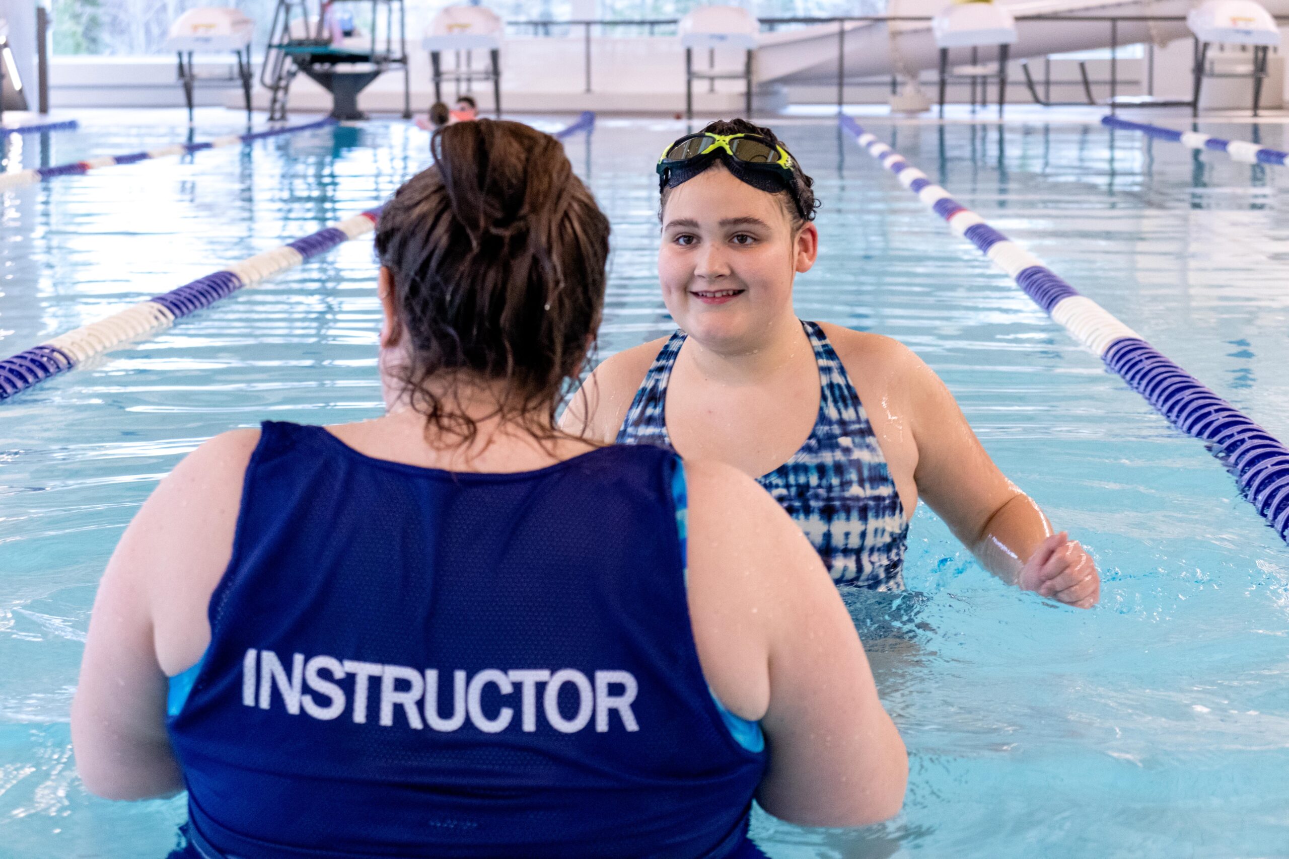 An instructor leads a student in an inclusion lesson