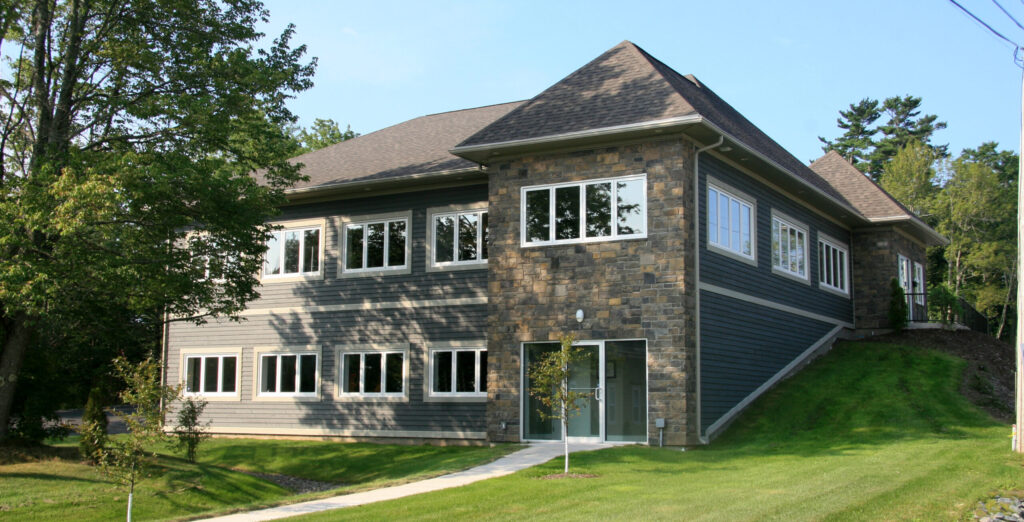A stonework and beige sided modern two-storey commercial office building.