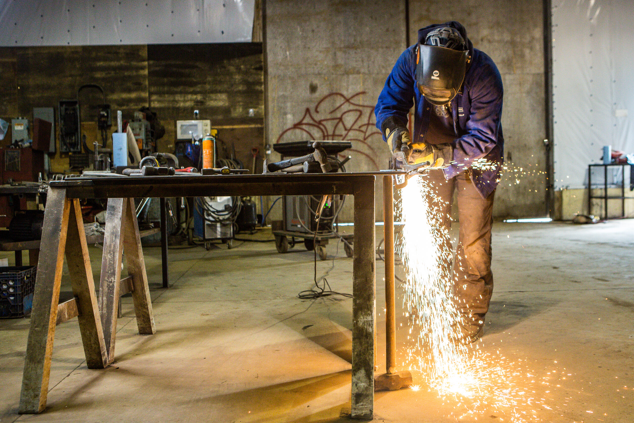 A welder working while sparks fly