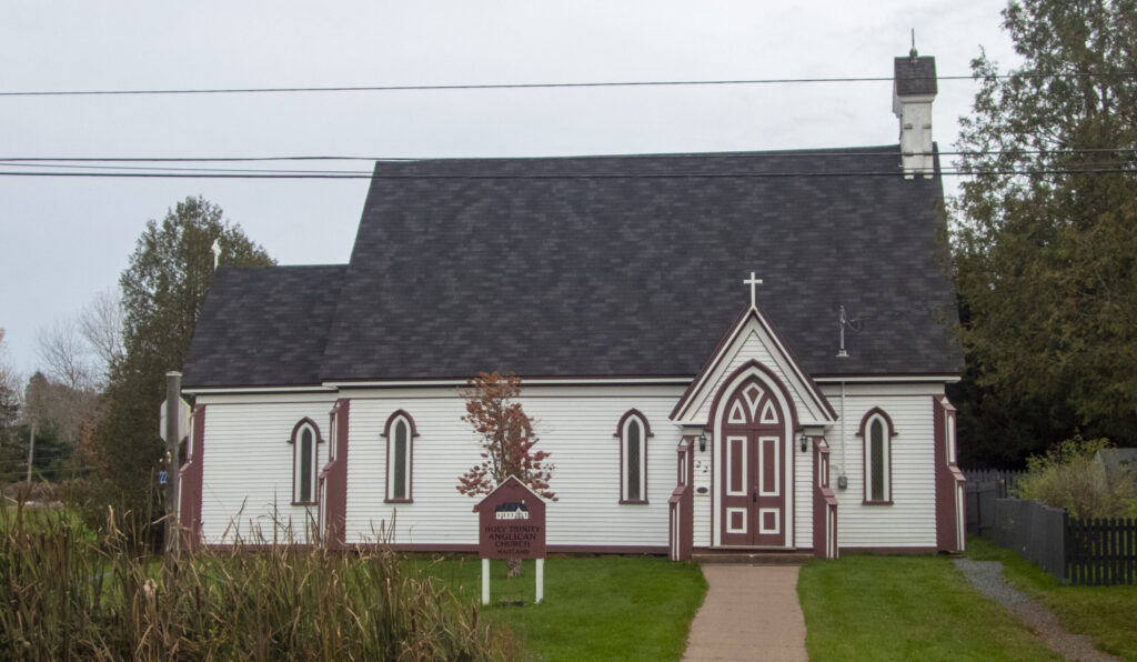 A small church with white painted siding and red painted trim.