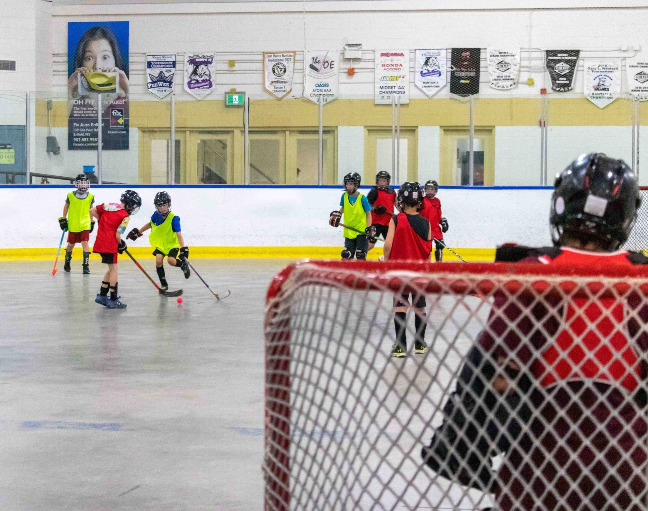 A group of children playing ball hockey